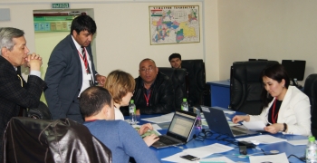 Participants strategize on best course of action in response to a simulated scenario related to nuclear material smuggling at the NNSA/NSDD workshop in Tajikistan.