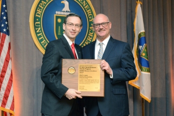 Gary Lyttek accepts his Directorâs Excellence Award. He also accepted the Federal Small Business Program Manager of the Year award on behalf of Gregory Gonzales.