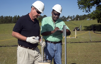 John Bradley, design authority engineer, left, and Joao Cardoso-Neto, Upper Three Runs project manager, both of Savannah River Nuclear Solutions, inspect a BaroBall unit.