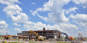 Equipment operators tear down the 18,100-square-foot contaminated facility located in the Poplar Creek area of the East Tennessee Technology Park.