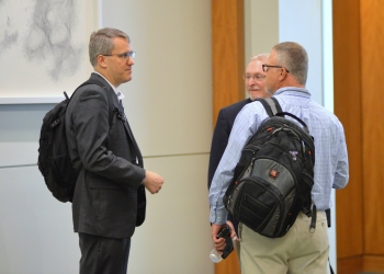 IT Governance & Enterprise Architect Jon Arlotti-Parish discusses IT issues with colleagues at NLIT.