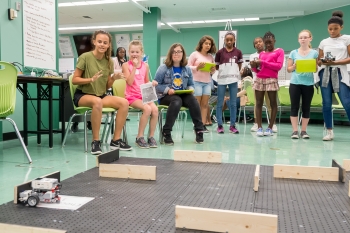 Participants in the CodeGirls@Argonne camp test their code by maneuvering a robot through a maze.