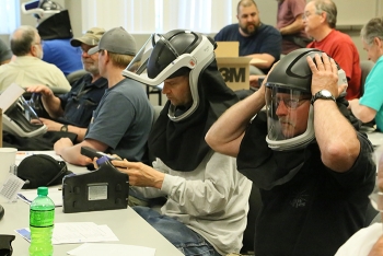 Bonneville Power Administration employees participate in hands-on training with helmets that contain powered air-purifying respirators in a course led by worker-trainers at the HAMMER Federal Training Center.