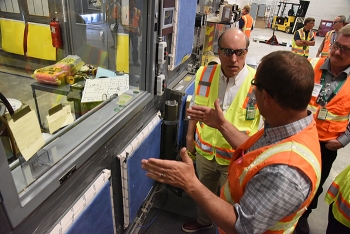 Fluor-Idaho Accelerated Retrieval Project Operations Manager Jason Chapple, left, briefs DOE Under Secretary for Science Paul Dabbar at the ARP VII, where crews size-reduce and decontaminate large items from the Advanced Mixed Waste Treatment Project.