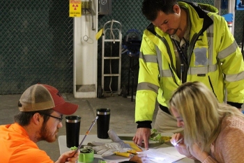 At right, Tim Medukas and Kaitlyn Weaver of RSI EnTech prepare materials while FBP project services technician Kyle Rase, left, observes.