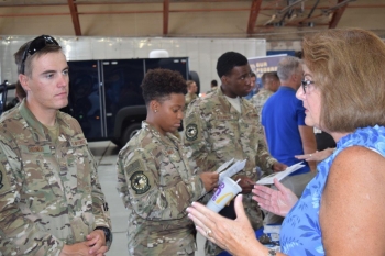 Tracy Loughead, acting manager of the OST Office of Training and Resources, talks to a Kirtland Air Force Base security force member about opportunities for federal agent employment when he leaves the military.