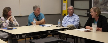 Left to right, EM Assistant Secretary Anne White talks with Bill Wilborn, Jhon Carilli, and Christine Baker of the EM Nevada Program during an all-hands meeting.