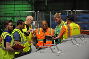 FBP's Rob Allyn demonstrates how to use a tablet to launch the Radpiper robot. From left, EM Fellow Michael DiBono; CMUâs David Kohanbash and William âRedâ Whittaker; Rod Rimando, Dir of EMâs Tech Dev Office; and FBP's Allyn and Brian Summers.