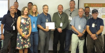 Current and former EM staff mark the last day of Lee Shenton (center) at the Moab Uranium Mill Tailings Remedial Action Project.