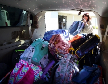 Adina Eliassian loads van with backpacks Adina Eliassian loads van with backpacks
