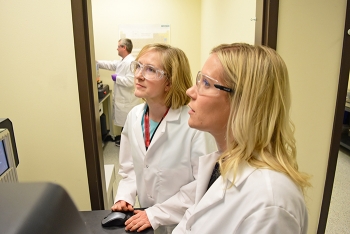 Two chemists train at a local college laboratory with equipment that will eventually be transferred to the Hanford Waste Treatment and Immobilization Plantâs Analytical Laboratory.