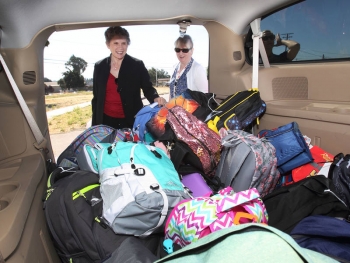 Dori Ellis loads van with backpacks Dori Ellis loads van with backpacks