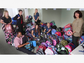 Volunteers organize backpacks Volunteers organize backpacks