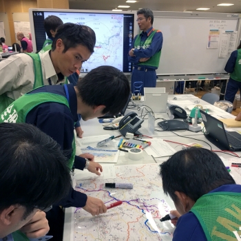 Japanese public safety team members plan out an evacuation route in the offsite center during the exercise.