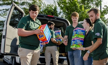 Supporting a Paducah Site community service outreach, college interns load supplies donated by the annual Feds Feed Families food drive for a western Kentucky charity.