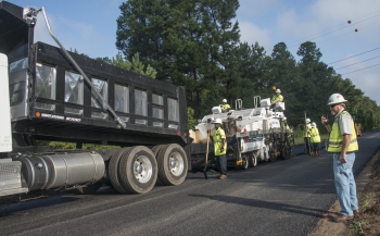 Savannah River Nuclear Solutions Subcontract Technical Representative Wayne Cadden, right, monitors crews as they resurface cracked, aging roads across the Savannah River Site.