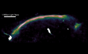 A radio image highlights a shock wave â seen here as the bright arc â in a merging cluster of galaxies.