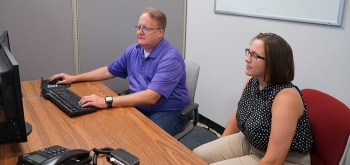 Savannah River Remediation Principal Cyber Specialist Sean Nixon, left, mentors high school student Colleen Harmon on cybersecurity applications.