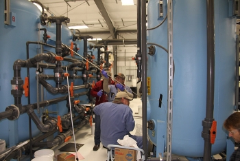 Workers upgrade tanks used to treat groundwater at the Hanford Site