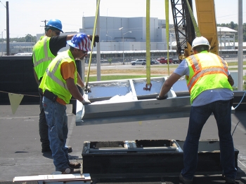 Crews installed new heating, ventilation, and air-conditioning units on an EM office building roof.
