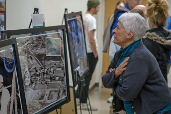 Attendee looks at a photo of the Climax Uranium Company Mill.