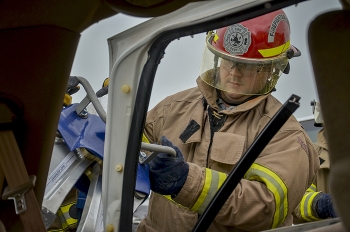 EM site worker Andrew Bachuss uses Jaws of Life to remove a vehicle door.