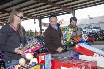 Savannah River Site employees sort toys prior to being loaded into several waiting trucks.