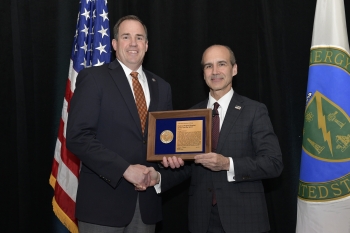 Dale Christenson, left, accepts his Federal Project Director of the Year award from Mark Menezes, Under Secretary of Energy.