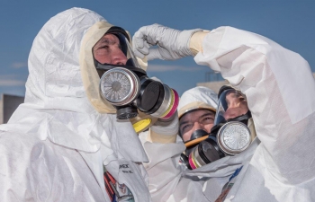 Radiological Assistance Program team members donned protective clothing and respirators in preparation for simulated entry into a contamination area.