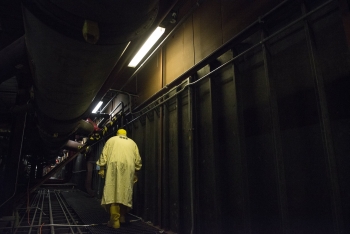 An employee at Y-12 National Security Complex walks through Building 9212.