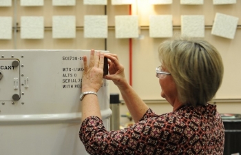 Melissa Jones applies the Federal QA stamp of approval to the final W76-1 nuclear weapon at the Pantex Plant in Amarillo, Texas.