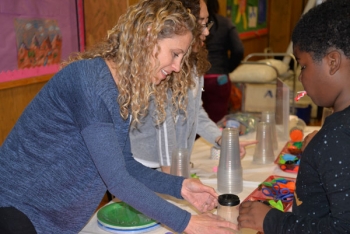Software engineer Marisa Stansfield helps a student build a balloon-launching âairzooka.â