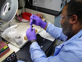 A Wastren Advantage Inc., employee tests a sample of tank waste at the 222-S Laboratory on the Hanford Site.