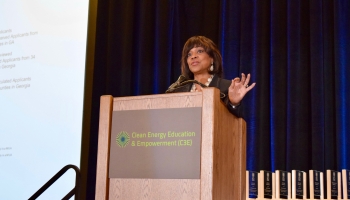 Dr. Valerie Montgomery Rice delivers the keynote address at the Clean Energy Education & Empowerment (C3E) symposium on December 3-4, 2018 Dr. Valerie Montgomery Rice stands at the podium, delivering the keynote address at the Clean Energy Education & Empowerment (C3E) symposium on December 3-4, 2018