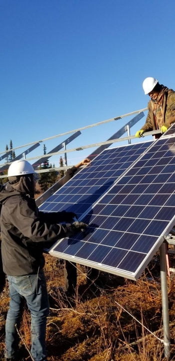 Alaska crew installing solar panels.