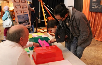 Concepts associated with bridge construction are tested by Liam Tom and his father Bryan under the watchful eye of electrical engineer Bill Reed.