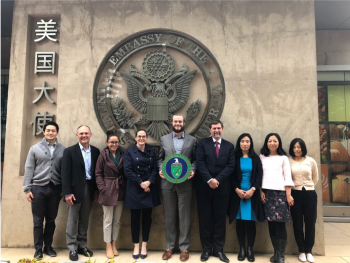Michael Yo, far left, and colleagues pose in front of the U.S. Embassy in Beijing.