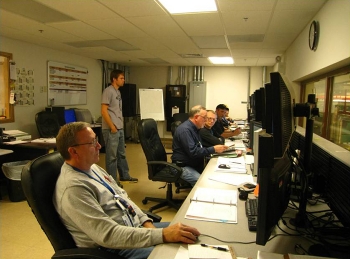Depleted Uranium Hexafluoride Conversion Project technicians monitor conversion facilities from a plant control room.