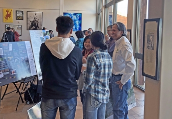Bill Frazier (LM) and May Picel (Argonne National Laboratory) discuss the Riverton, Wyoming, Site with students at a Northern Arapaho event.