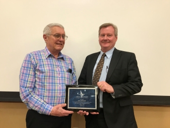 Keith Branter (left), former ICP CAB Chair, receives a plaque commemorating his service from DOEâs Jack Zimmerman at the April 25, 2019 meeting in Twin Falls.