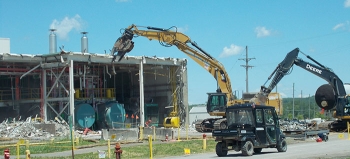 A crew demolishes two boilers at the former utility room extension building. Workers then size-reduced and packaged them for off-site disposal.