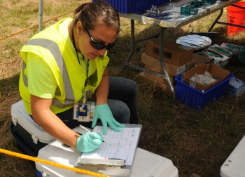 A technician enters environmental media data into report records as part of DOE's Portsmouth Environmental Monitoring program.