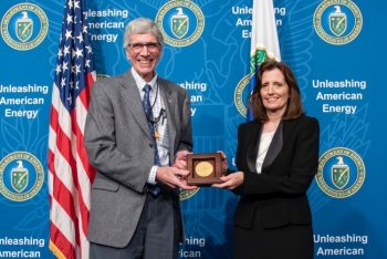 Dr. Charles Verdon, NNSAâs Deputy Administrator for Defense Programs, presents Dr. Kathi Alexander with the NNSA gold seal for her exceptional service for more than 30 years.