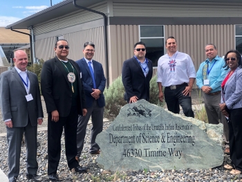 Staff from DOE and CTUIR assemble around a sign for the CTUIR Department of Science & Engineering building. See caption for names.
