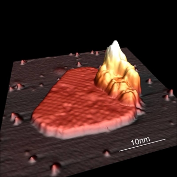 A faceted metal island of the rare-earth element dysprosium formed under a layer of graphite. The team deposited the metal at 577 degrees Celsius after they bombarded graphite with argon ions. A faceted metal island of the rare-earth element dysprosium formed under a layer of graphite. The team deposited the metal at 577 degrees Celsius after they bombarded graphite with argon ions.