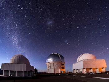 Researchers used the Blanco telescope in conducting the Dark Energy Survey. The Milky Way is on the left of the sky, with the Magellanic clouds in the center. Researchers used the Blanco telescope in conducting the Dark Energy Survey. The Milky Way is on the left of the sky, with the Magellanic clouds in the center.