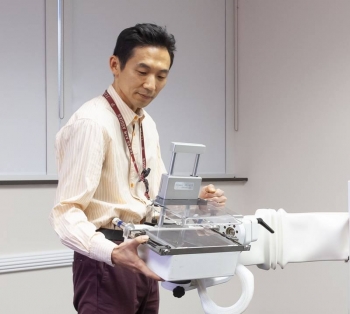 Seung Joon Lee holds the variable angle slant hole collimator. This device can help a breast molecular imaging system get six times better contrast of cancer lesions, providing the same or better image quality while potentially halving the radiation dose. Seung Joon Lee holds the variable angle slant hole collimator. This device can help a breast molecular imaging system get six times better contrast of cancer lesions, providing the same or better image quality while potentially halving the radiation dose.