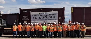 Employees at the Crescent Junction disposal cell site come together to mark the milestone as they await the train carrying the 10 millionth ton from the Moab Uranium Mill Tailings Remedial Action Project.