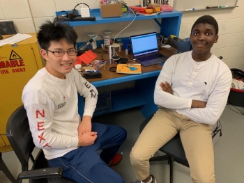 Building a levitator: Alex Ni, left, and Remy Plattiers, with the levitator beside the computer behind them. Building a levitator: Alex Ni, left, and Remy Plattiers, with the levitator beside the computer behind them.