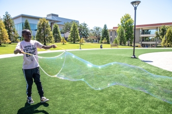 Proving that science can be fun, middle school students at the lab's CORE Science Institute made giant soap bubbles to learn about thin film interference, which happens when light reflects off the two thin layers of soap film that form a bubble. Proving that science can be fun, middle school students at the lab's CORE Science Institute made giant soap bubbles to learn about thin film interference, which happens when light reflects off the two thin layers of soap film that form a bubble.